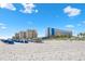 Beautiful white sandy beach with multiple high-rise hotels at 11 San Marco St # 407, Clearwater Beach, FL 33767