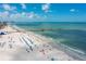 Expansive aerial view of the beach showcasing the pier, umbrellas, and ocean, highlighting the coastal lifestyle at 11 San Marco St # 407, Clearwater Beach, FL 33767