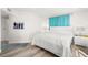 Well-lit bedroom with white walls, hardwood floors, and modern decor at 11 San Marco St # 407, Clearwater Beach, FL 33767