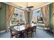 Bright dining room featuring large windows, a modern ceiling fan, and elegant floral curtains at 11 San Marco St # 407, Clearwater Beach, FL 33767