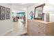 Inviting entryway with a decorative dresser, mirror, and hallway leading to a bright living area at 11 San Marco St # 407, Clearwater Beach, FL 33767