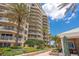 Luxury condominium building with lush landscaping and resort-style pool at 11 San Marco St # 407, Clearwater Beach, FL 33767