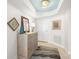 Bright condo foyer featuring neutral walls, striking decor, light-colored wooden cabinet and tile flooring at 11 San Marco St # 407, Clearwater Beach, FL 33767