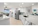 Bright condo kitchen with stainless steel appliances, white cabinetry and tile floors at 11 San Marco St # 407, Clearwater Beach, FL 33767