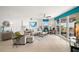 A well-lit living room is equipped with a ceiling fan, comfortable seating, and access to a balcony with nice views at 11 San Marco St # 407, Clearwater Beach, FL 33767
