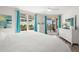 Bright main bedroom featuring a walkout balcony, white furnishings and a ceiling fan at 11 San Marco St # 407, Clearwater Beach, FL 33767