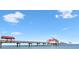 Scenic view of a long pier extending into the ocean under a blue sky at 11 San Marco St # 407, Clearwater Beach, FL 33767
