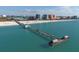 Stunning aerial view of a pier over turquoise water at 11 San Marco St # 407, Clearwater Beach, FL 33767