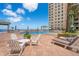Inviting outdoor pool area with lounge chairs and ocean views at 11 San Marco St # 407, Clearwater Beach, FL 33767