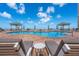 Beautiful pool area with lounge chairs and cabanas, offering a relaxing view of the ocean at 11 San Marco St # 407, Clearwater Beach, FL 33767