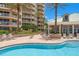 Beautiful community pool, sun loungers, and manicured landscaping at 11 San Marco St # 407, Clearwater Beach, FL 33767