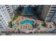 Overhead shot of the unique community pool nestled between two luxury condo buildings with lush landscaping at 11 San Marco St # 407, Clearwater Beach, FL 33767