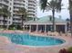 Luxury condo featuring a beautiful pool and lounge chairs at 11 San Marco St # 407, Clearwater Beach, FL 33767