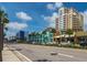 Bustling street with palm trees and colorful buildings in a vibrant coastal community at 11 San Marco St # 407, Clearwater Beach, FL 33767