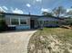 Charming single-story home with blue brick exterior and inviting front walkway at 1105 Connecticut Rd, Tarpon Springs, FL 34689