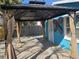 Outdoor entertaining area with a patio, pergola, palm trees, and tropical landscaping at 126 119Th Ave, Treasure Island, FL 33706