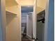 Bathroom closet featuring built-in shelving and a glimpse into the bathroom with a white shower at 126 119Th Ave, Treasure Island, FL 33706