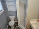 Classic bathroom featuring a white toilet, shower, and black and white tiled flooring at 126 119Th Ave, Treasure Island, FL 33706