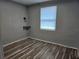 Cozy bedroom featuring modern wood-look flooring and a built-in shelf with overhead lighting at 126 119Th Ave, Treasure Island, FL 33706