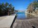 Concrete boat ramp and wooden dock with access to waterfront residences and boat mooring at 126 119Th Ave, Treasure Island, FL 33706