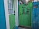 Close-up of a charming entrance with a vibrant green door, decorative bird artwork, and a 'Private Property' sign at 126 119Th Ave, Treasure Island, FL 33706