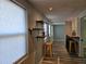 Hallway featuring wood-look floors, natural light from windows, and a functional bar area at 126 119Th Ave, Treasure Island, FL 33706