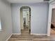 Hallway view showcasing wood-look floors, access to bathroom, and neutral paint throughout at 126 119Th Ave, Treasure Island, FL 33706