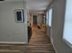 Hallway featuring wood-look floors, natural light from windows, and a functional bar area at 126 119Th Ave, Treasure Island, FL 33706