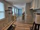 Kitchen featuring wood-look floors, natural light from a window, and convenient floating shelves at 126 119Th Ave, Treasure Island, FL 33706