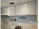 Kitchen area featuring white cabinetry and wall art at 126 119Th Ave, Treasure Island, FL 33706