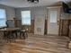 Open living room with wood-look tile floors and exposed concrete walls, showing remodeling potential at 126 119Th Ave, Treasure Island, FL 33706