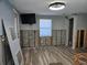 Living room with wood-look tile, ready for renovation, featuring block walls, and natural light at 126 119Th Ave, Treasure Island, FL 33706