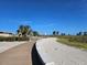 Exterior walking path with palm trees and lush landscaping leading to the beach at 126 119Th Ave, Treasure Island, FL 33706