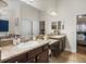Bathroom featuring double vanity with granite countertops, tile flooring, and a large mirror at 13302 Trailing Moss Dr, Dade City, FL 33525