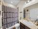 Bathroom showcasing a vanity with a granite countertop and a shower with a curtain at 13302 Trailing Moss Dr, Dade City, FL 33525