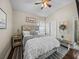 Comfortable bedroom with a vaulted ceiling, a ceiling fan and an abundance of natural light at 13302 Trailing Moss Dr, Dade City, FL 33525