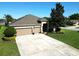 Charming single-story home featuring a well-maintained lawn and a convenient two-car garage at 13302 Trailing Moss Dr, Dade City, FL 33525