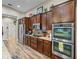 Modern kitchen featuring stainless steel appliances, granite countertops, and ample cabinet space at 13302 Trailing Moss Dr, Dade City, FL 33525