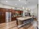 Well-appointed kitchen with granite counters, large island, stainless steel appliances, and modern lighting fixtures at 13302 Trailing Moss Dr, Dade City, FL 33525