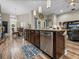 Kitchen island featuring a stainless steel dishwasher, wine cooler and granite countertops at 13302 Trailing Moss Dr, Dade City, FL 33525