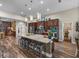 Spacious kitchen with large center island, granite countertops, stainless steel appliances, and pendant lighting at 13302 Trailing Moss Dr, Dade City, FL 33525