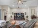 Inviting living room featuring hardwood floors, neutral tones, and comfortable seating arrangement at 13302 Trailing Moss Dr, Dade City, FL 33525