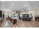 Spacious living room features hardwood floors, a large island and an open layout great for entertaining at 13302 Trailing Moss Dr, Dade City, FL 33525