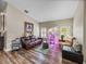 Inviting living room featuring hardwood floors, large windows, and comfortable furniture at 13302 Trailing Moss Dr, Dade City, FL 33525