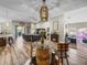 Bright open-concept living space with cozy fireplace, barrel table, modern ceiling fan, and sliding door to the lanai at 13302 Trailing Moss Dr, Dade City, FL 33525