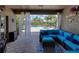 Covered patio with cozy outdoor furniture, overlooking the pool and backyard at 13302 Trailing Moss Dr, Dade City, FL 33525