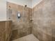 This shower features stone tile and a showerhead at 13302 Trailing Moss Dr, Dade City, FL 33525