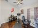 This workout room features hardwood floors, a ceiling fan, and a stationary bike at 13302 Trailing Moss Dr, Dade City, FL 33525