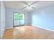 Bright bedroom with light wood floors, fan and sliding doors to the balcony at 1424 Highland Ridge Cir, Brandon, FL 33510