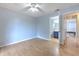 View of bedroom with ceiling fan, and doorway to adjacent bath and hall at 1424 Highland Ridge Cir, Brandon, FL 33510